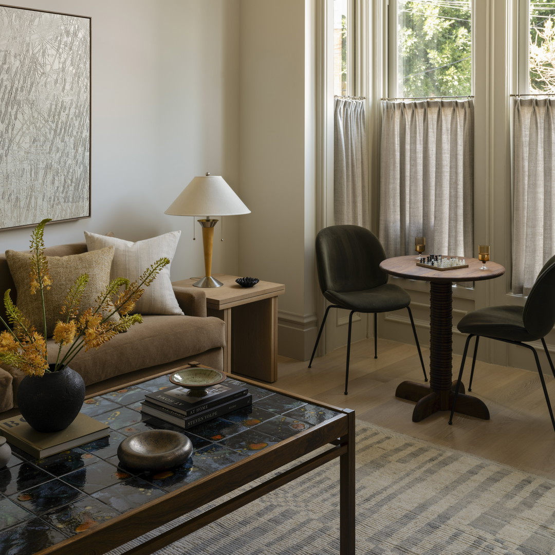 a living room filled with furniture and windows