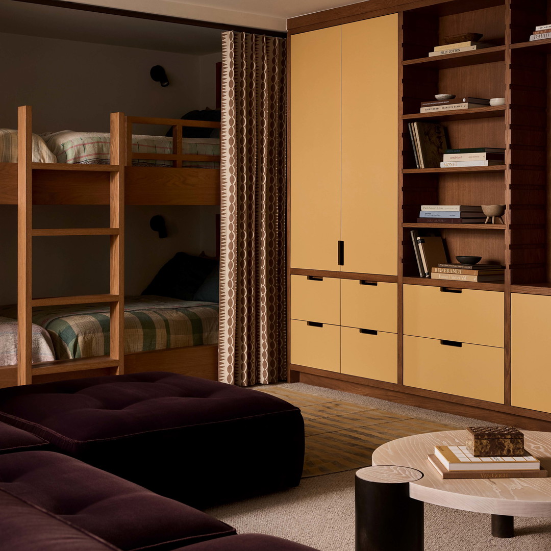 a living room filled with furniture and a book shelf