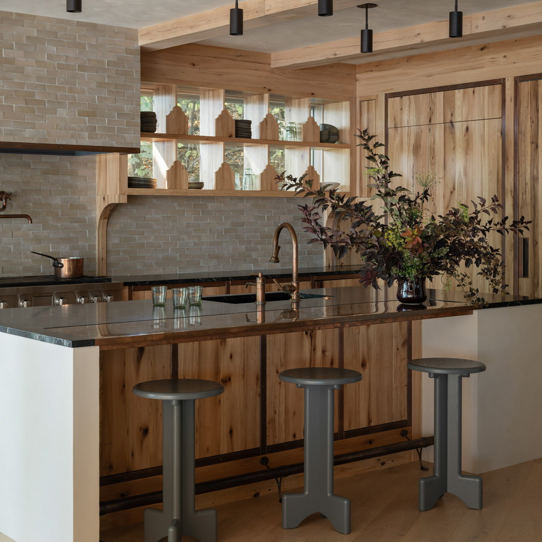 a kitchen with a center island with stools