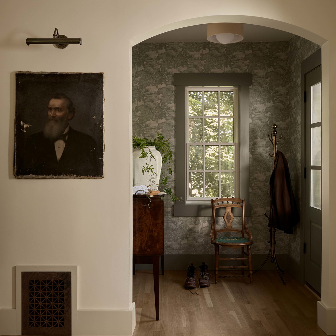 a room with a chair and a painting on the wall