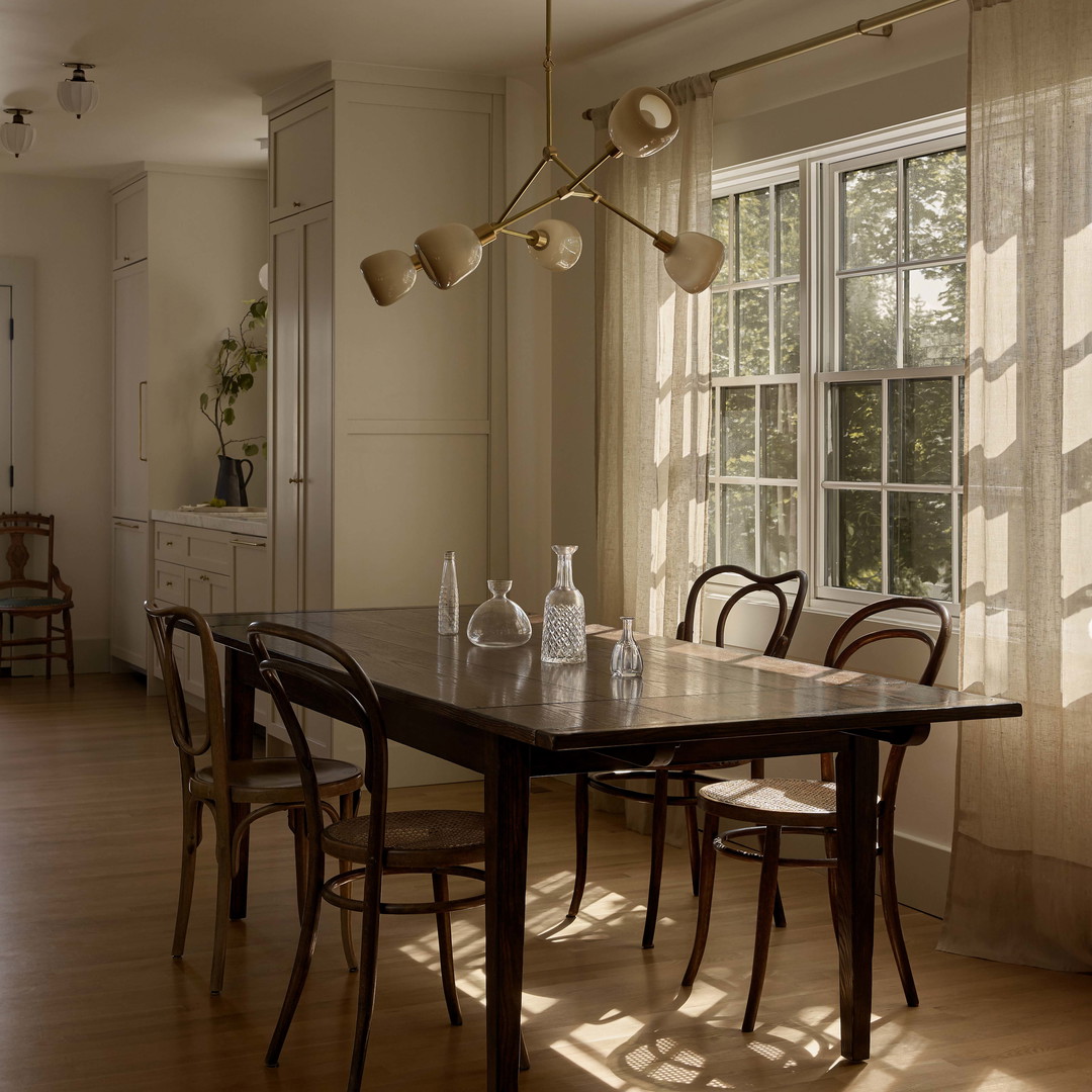 a dining room with a table and chairs