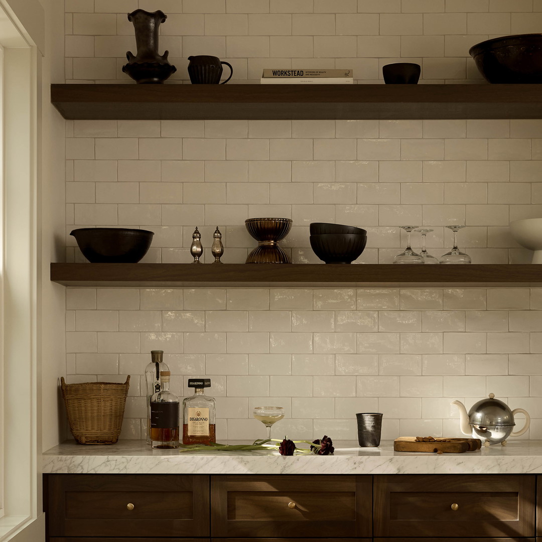 a kitchen with wooden cabinets and shelves filled with dishes