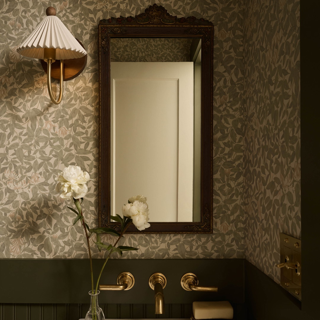 a white sink sitting under a mirror in a bathroom