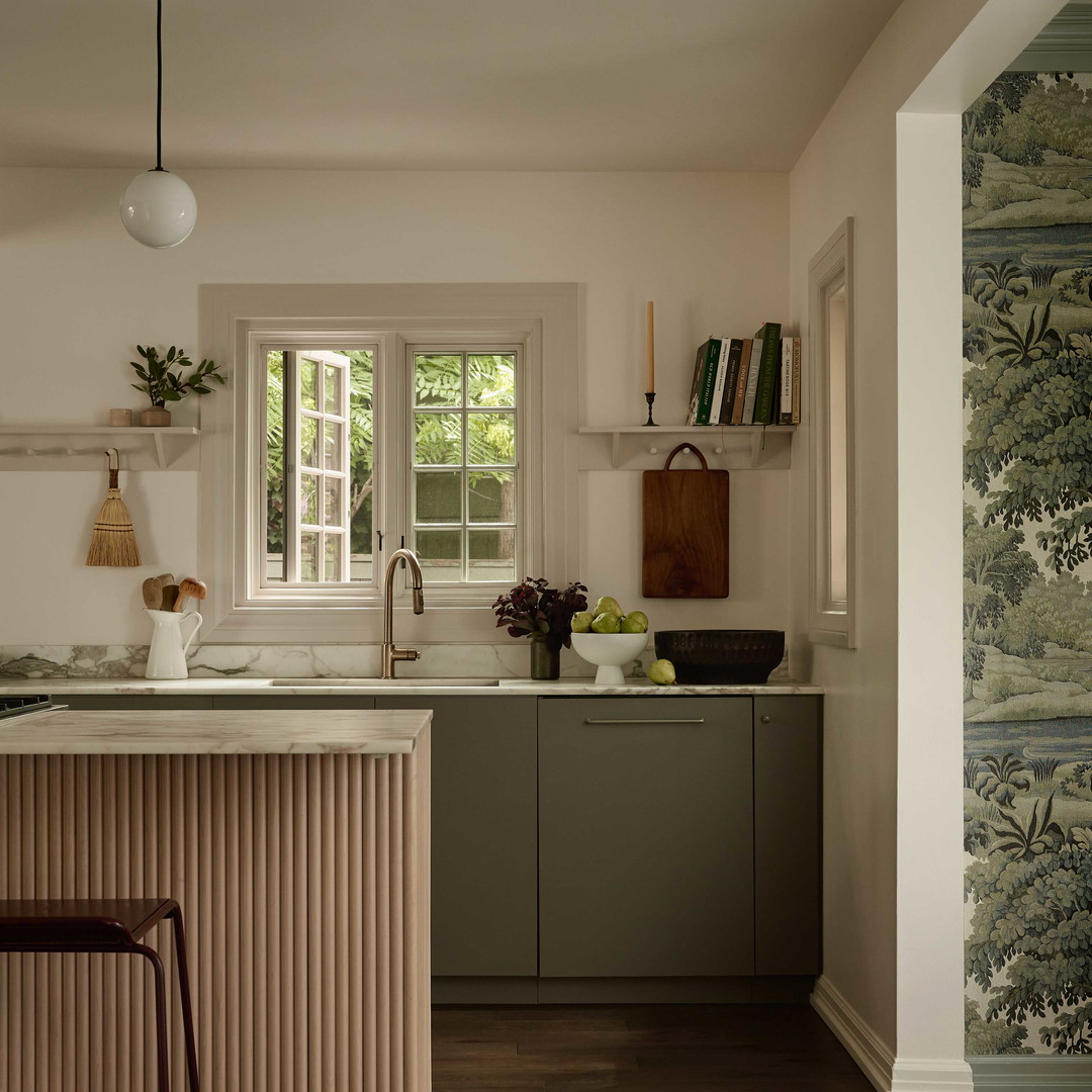 a kitchen with a bar stool and a sink