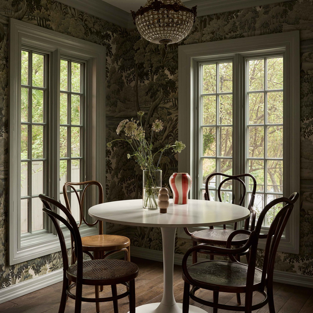 a dining room with a table and chairs