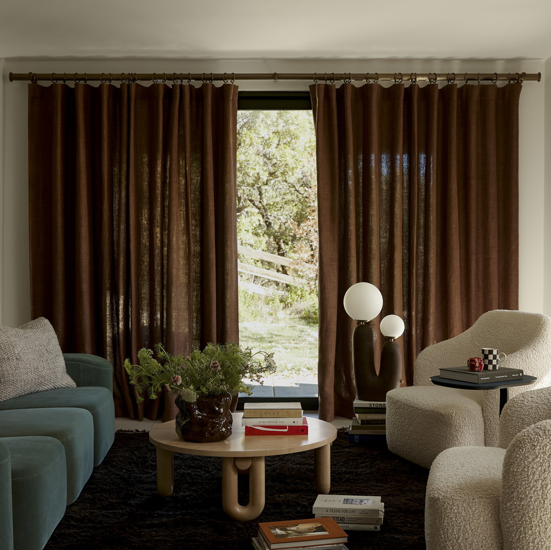 a living room filled with furniture and a large window