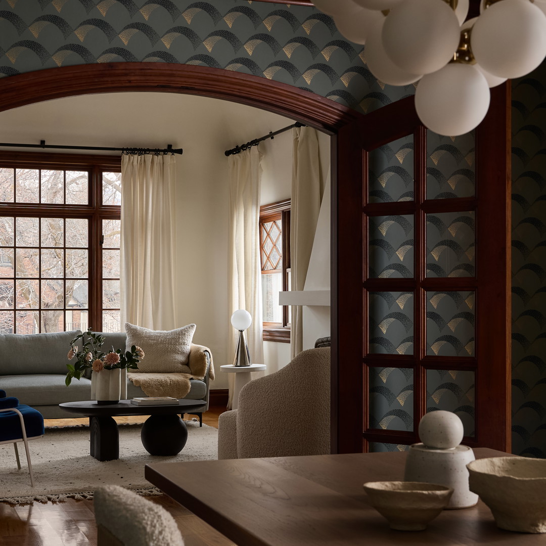 a living room filled with furniture and lots of windows