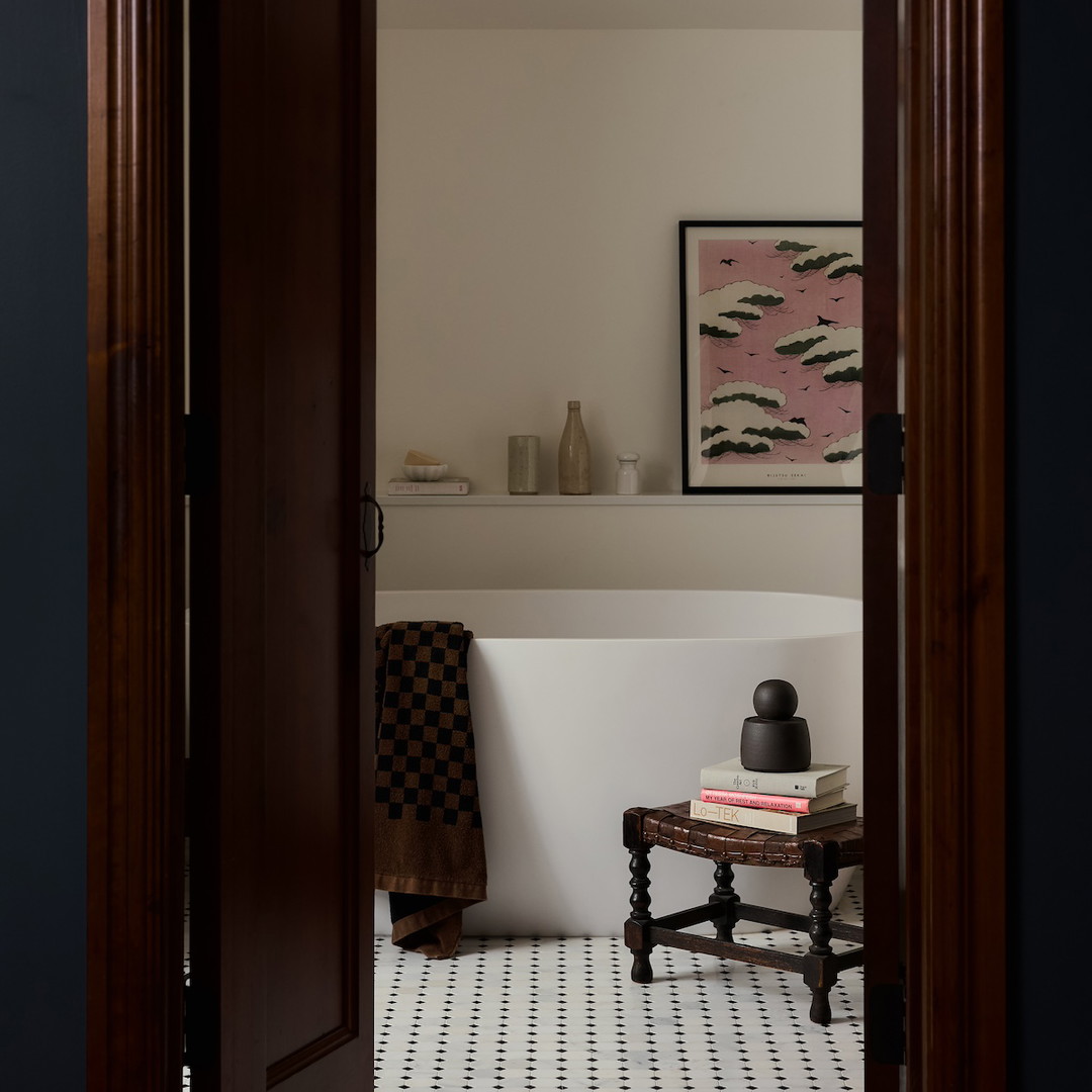 a bath room with a bath tub and a table