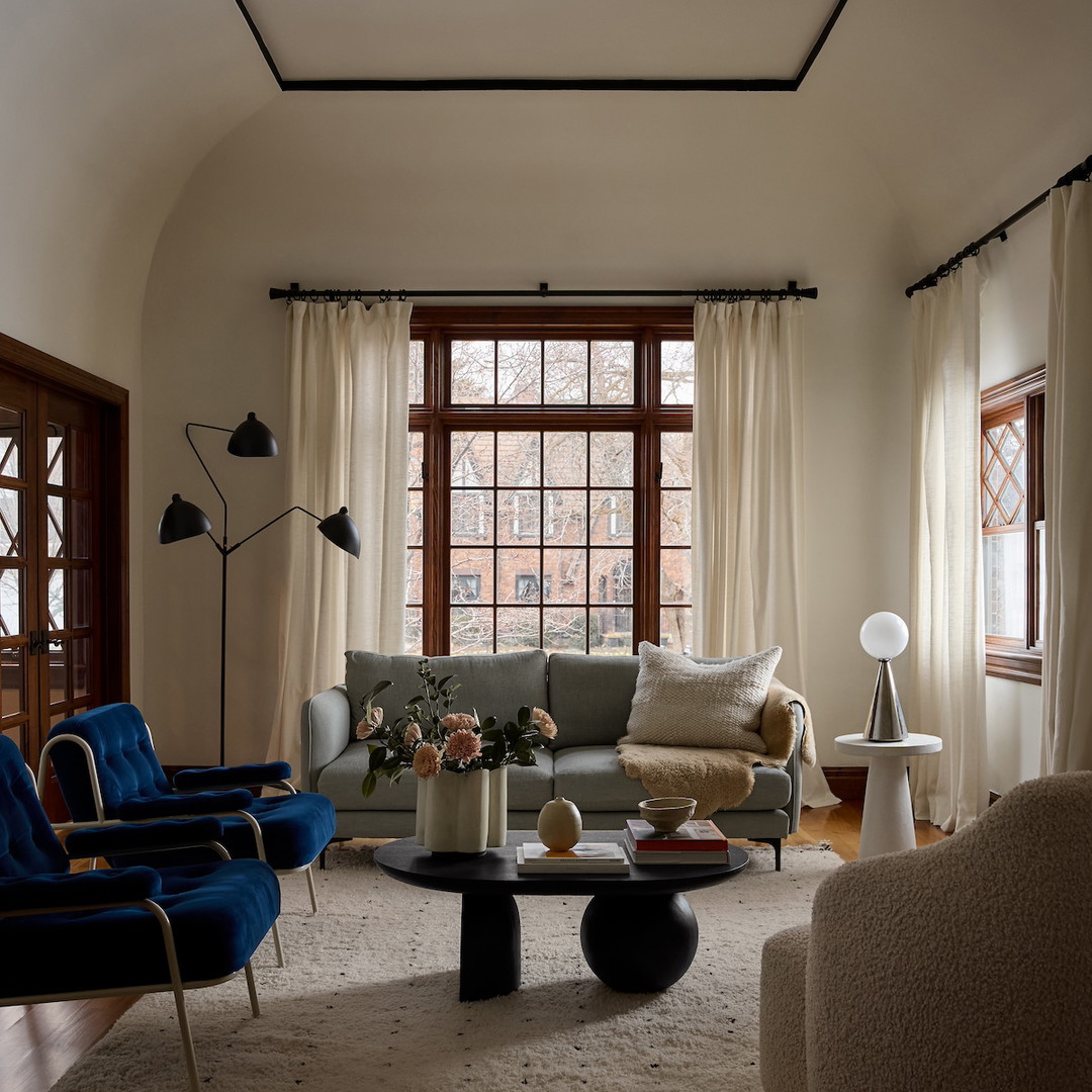 a living room filled with furniture and a large window