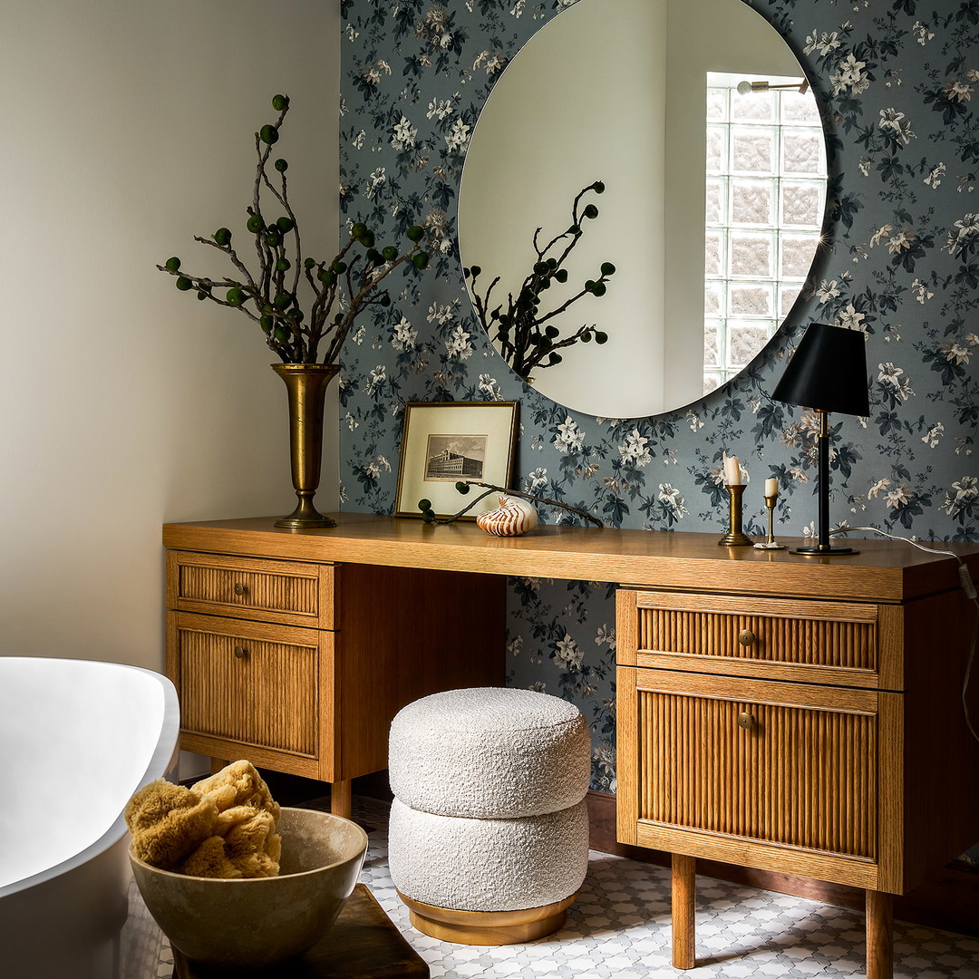 a room with a vanity, mirror, and stool