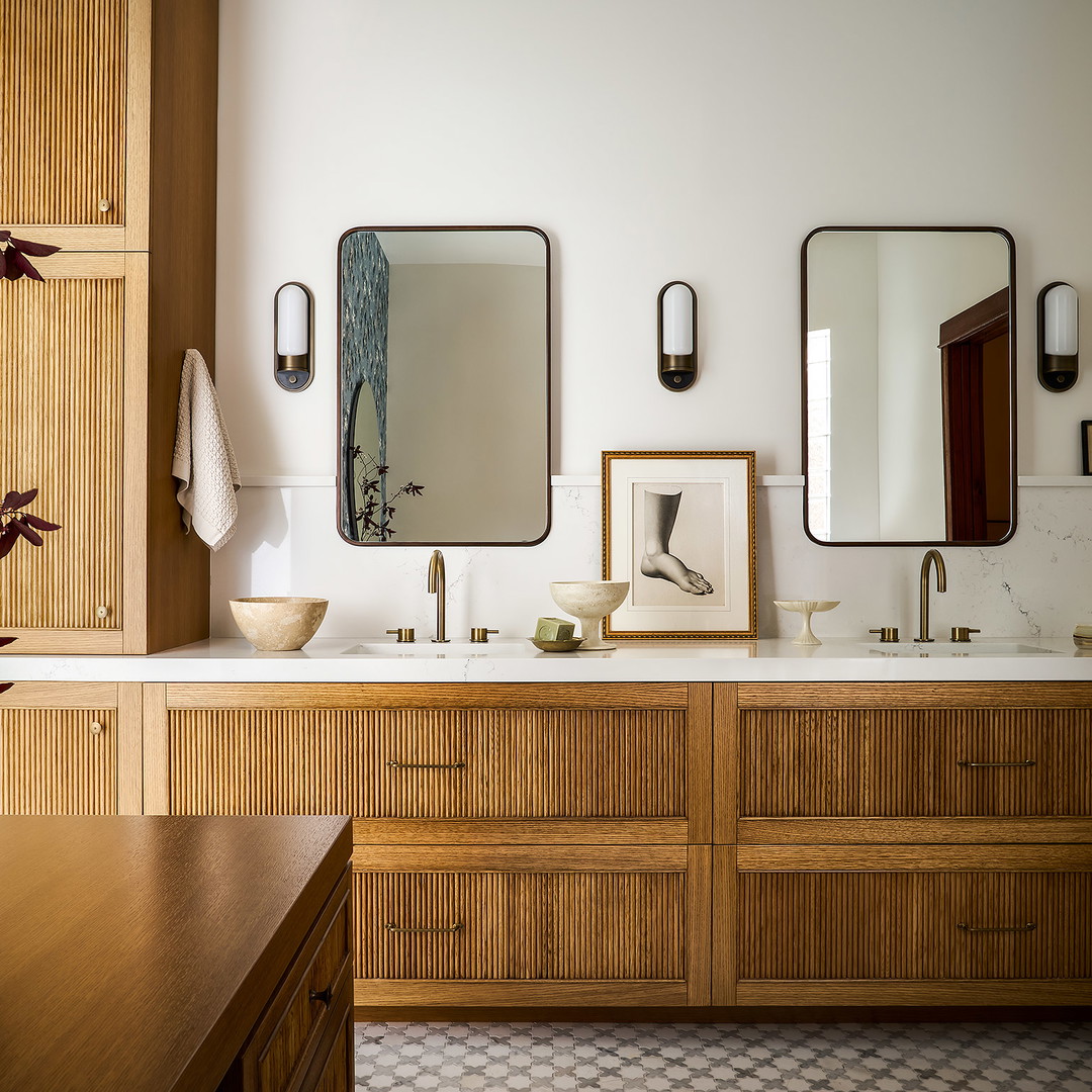 a bathroom with two sinks and a mirror