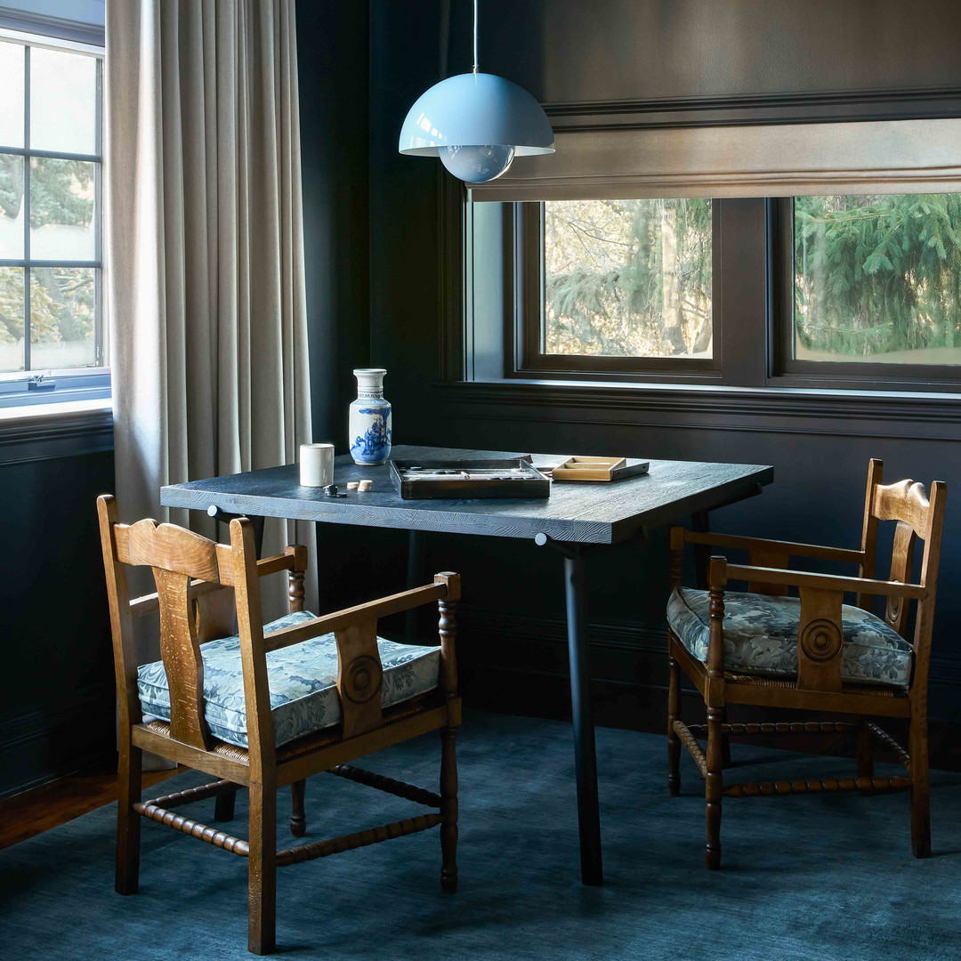 a dining room with a table and two chairs