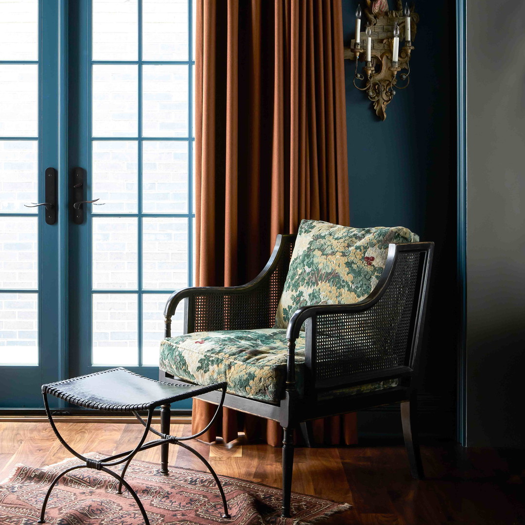 a living room with blue walls and curtains