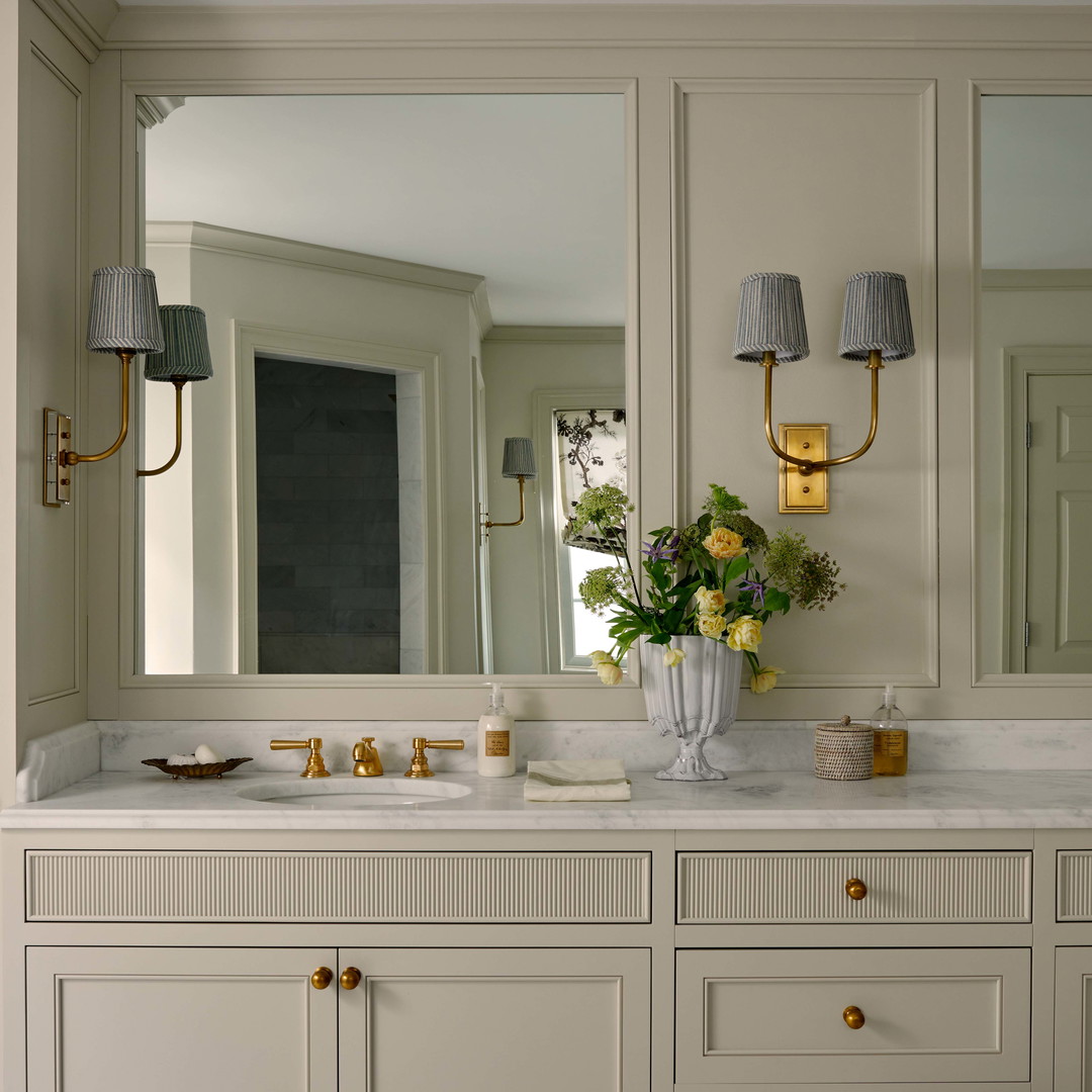 a bathroom with two sinks and a large mirror