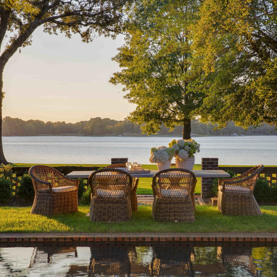 a table and chairs sitting on top of a lush green field