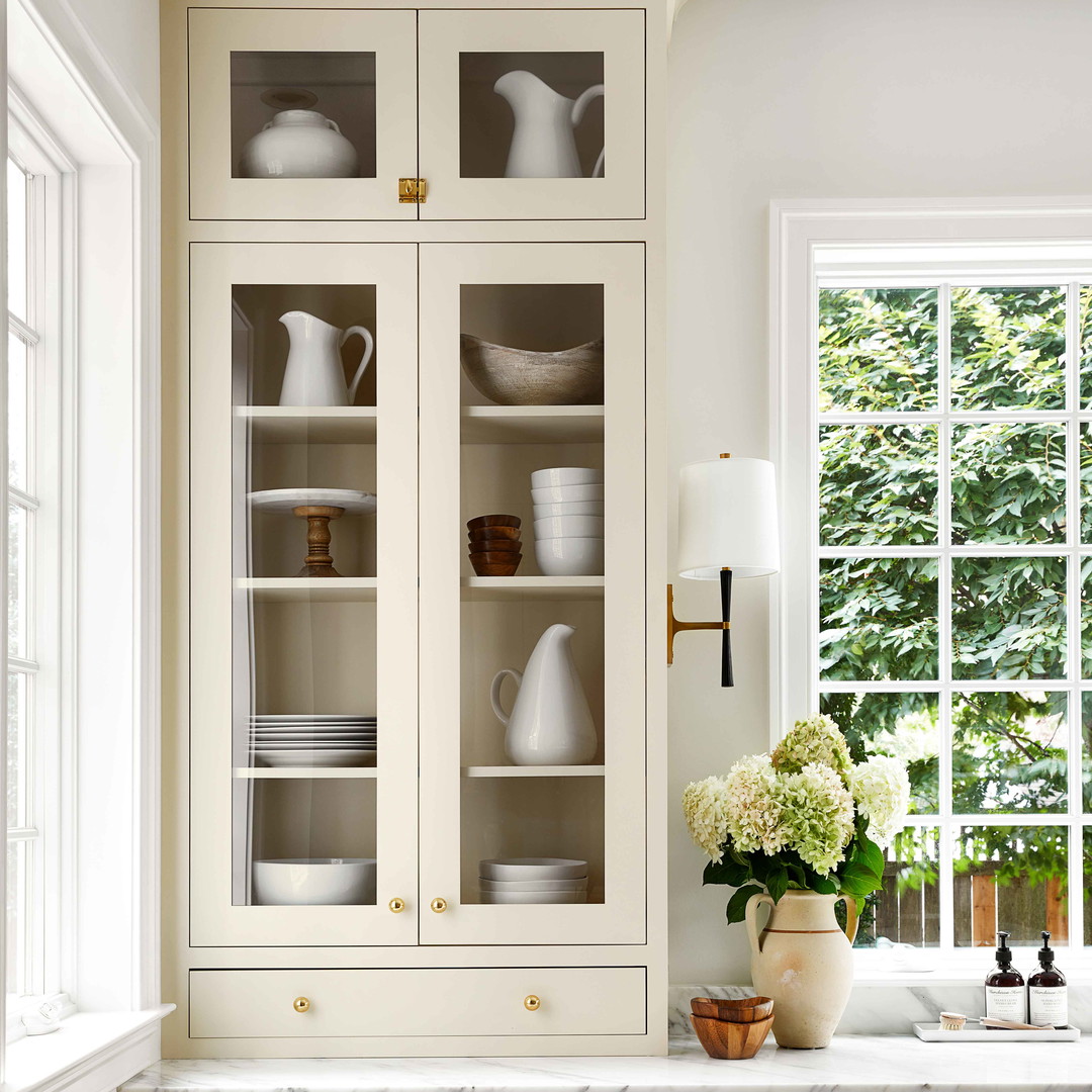 a kitchen with white cabinets and white counter tops