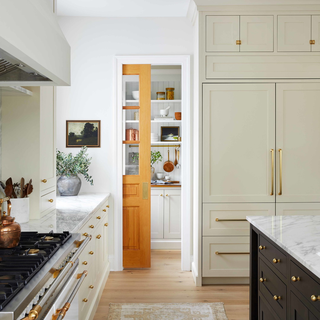 a kitchen with a stove, oven, cabinets and a rug