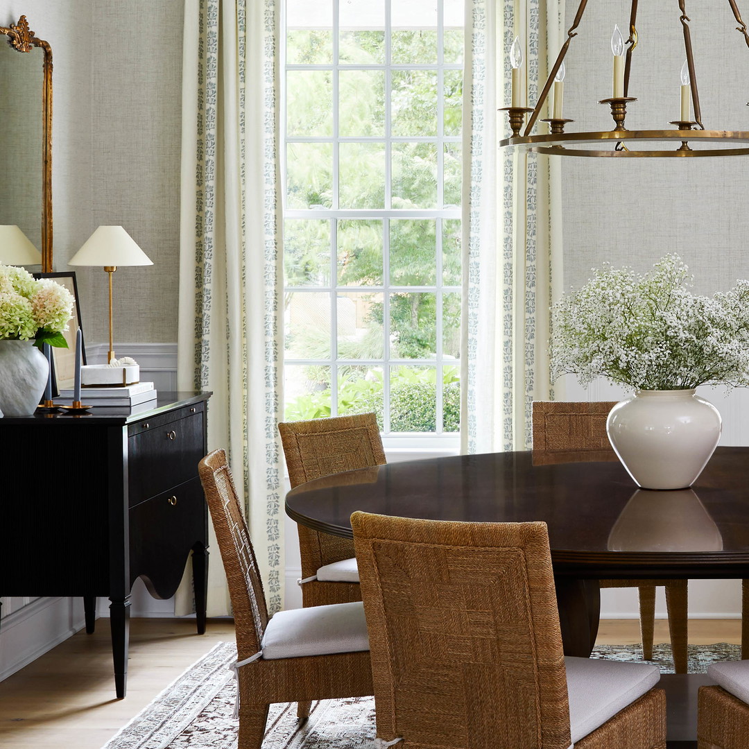 a dining room with a table and chairs and a chandelier