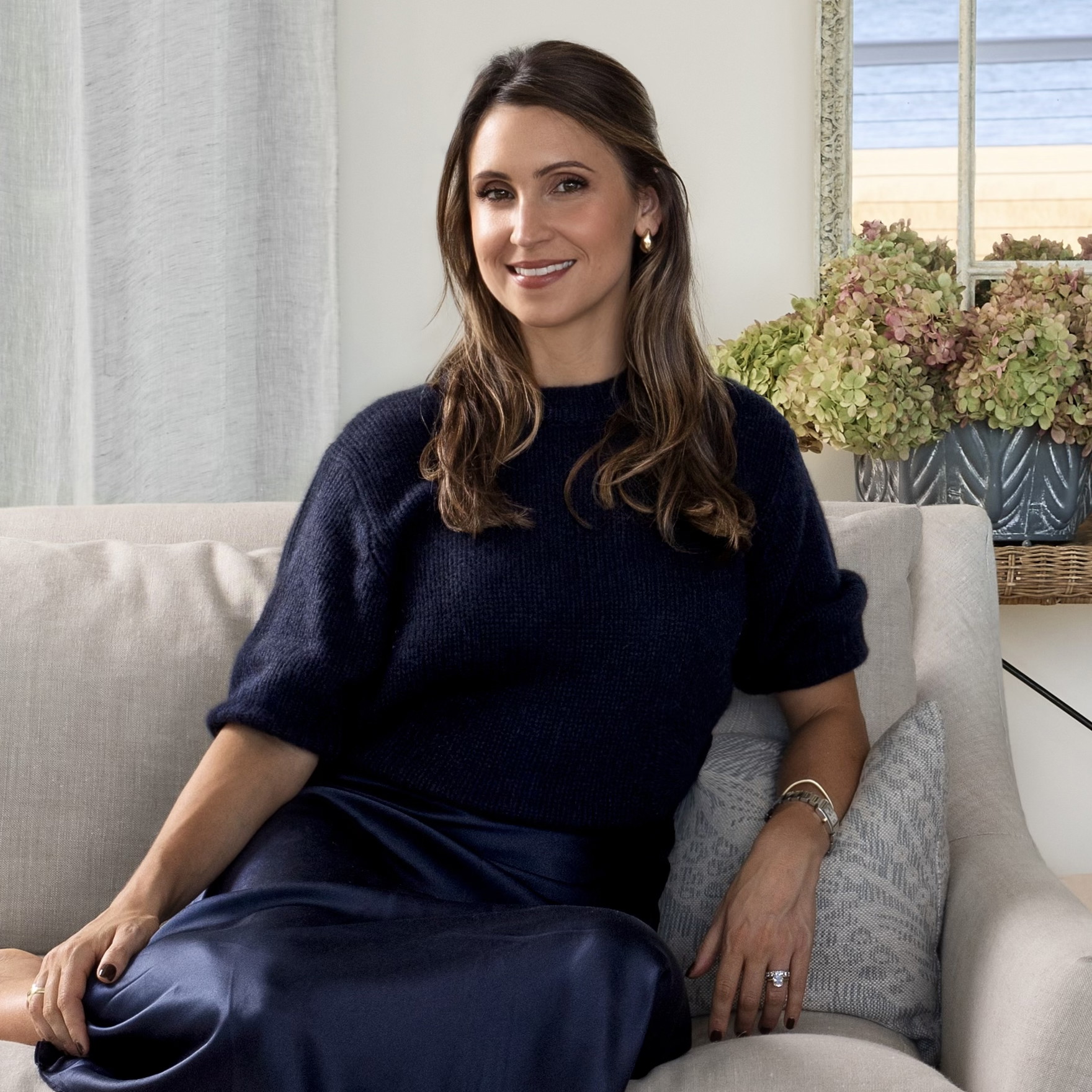 a woman sitting on a couch in a living room