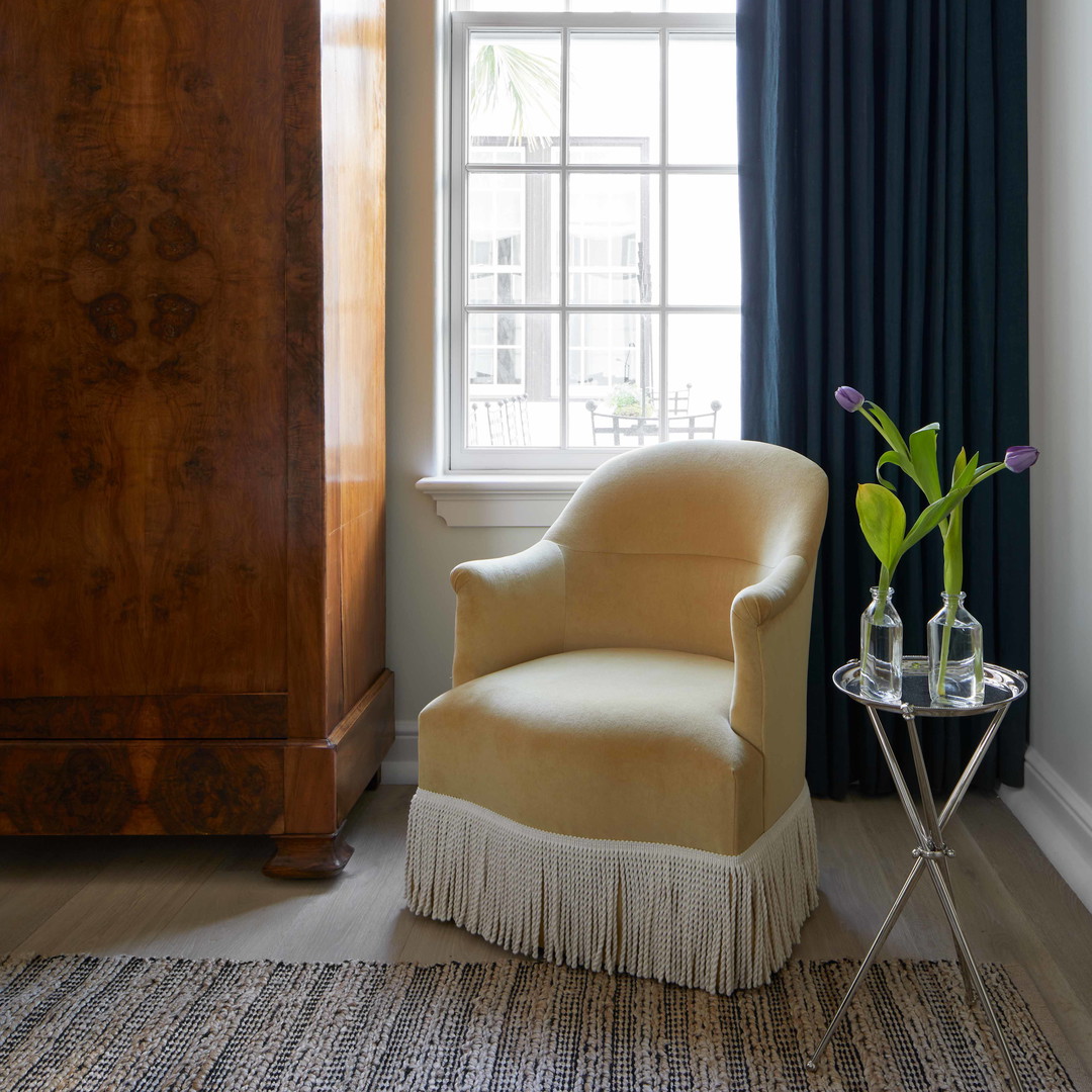 a living room with a chair and a window