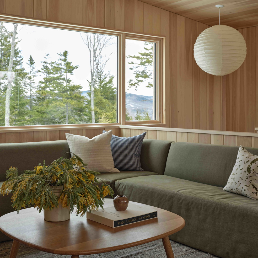 a living room filled with furniture and a large window