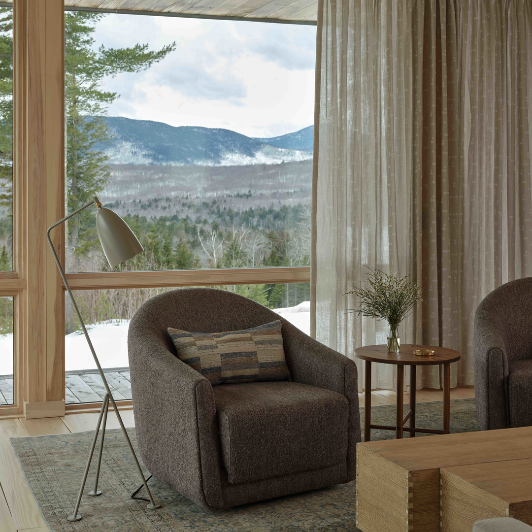 a living room filled with furniture and a large window