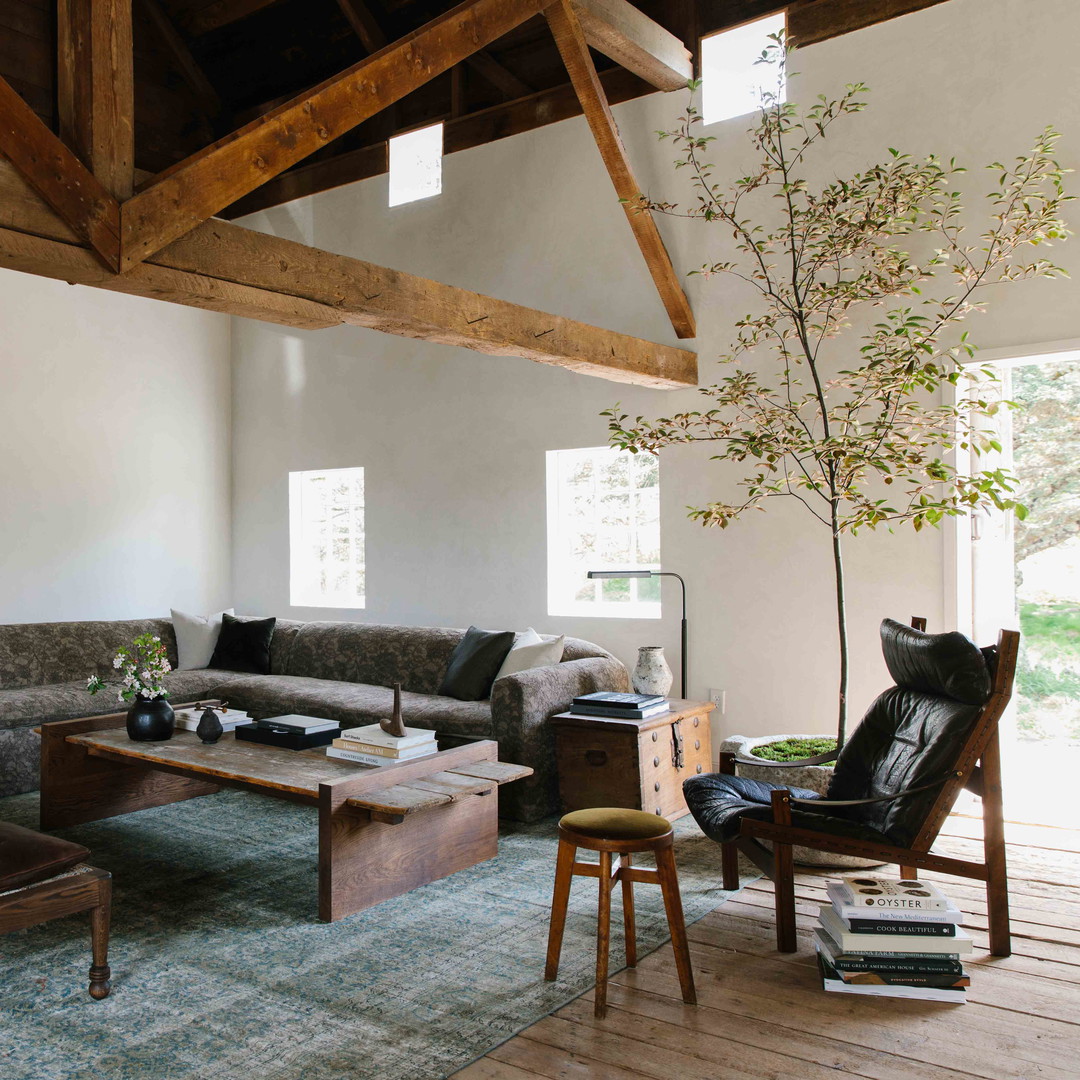 a living room filled with furniture and a wooden ceiling