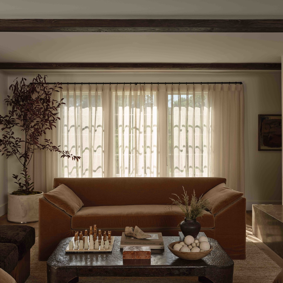 a living room filled with furniture and a window