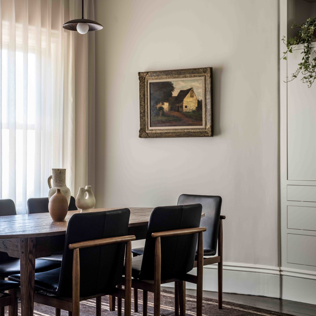 a dining room with a table and chairs