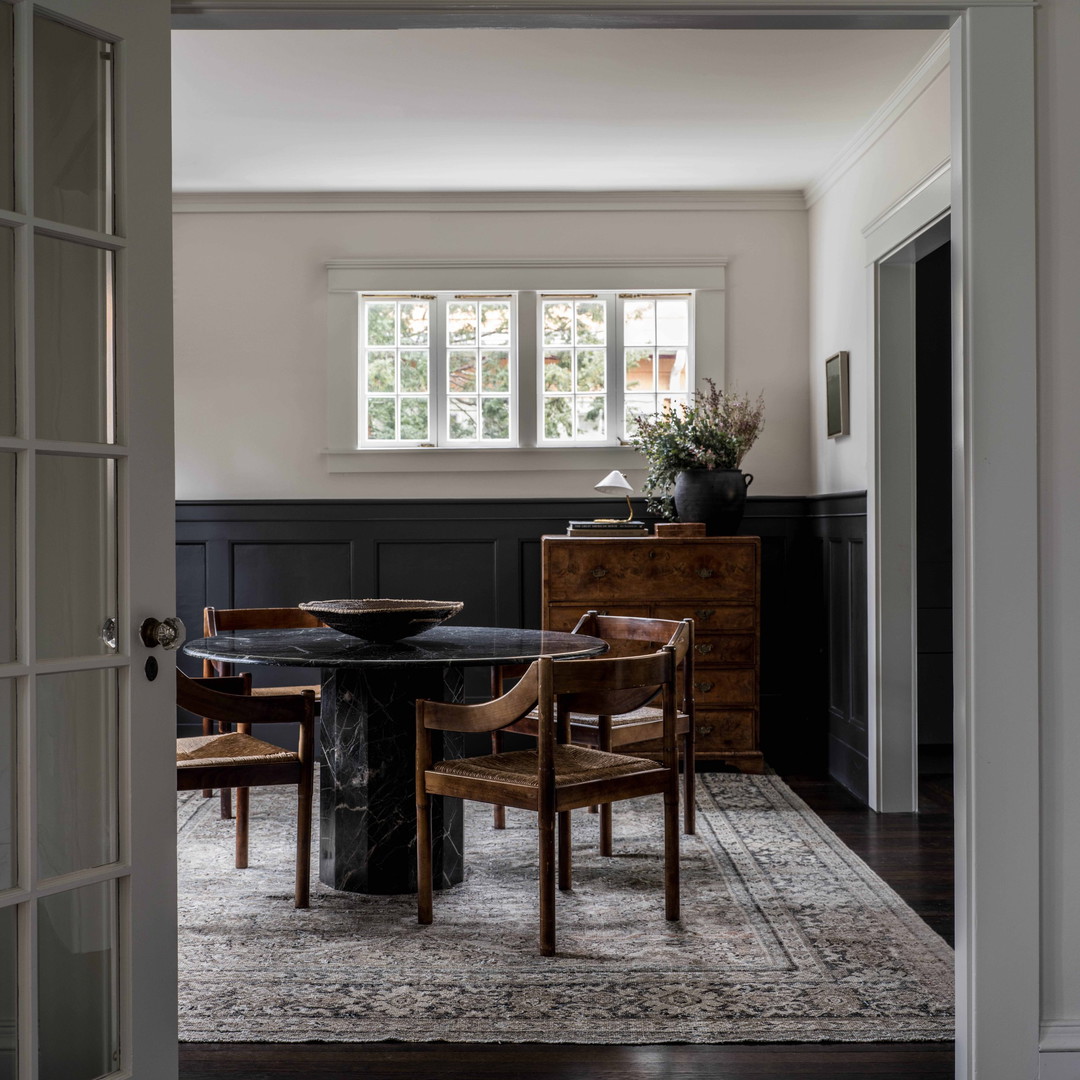 a dining room with a table and chairs