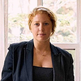 a woman standing in front of a table in a room