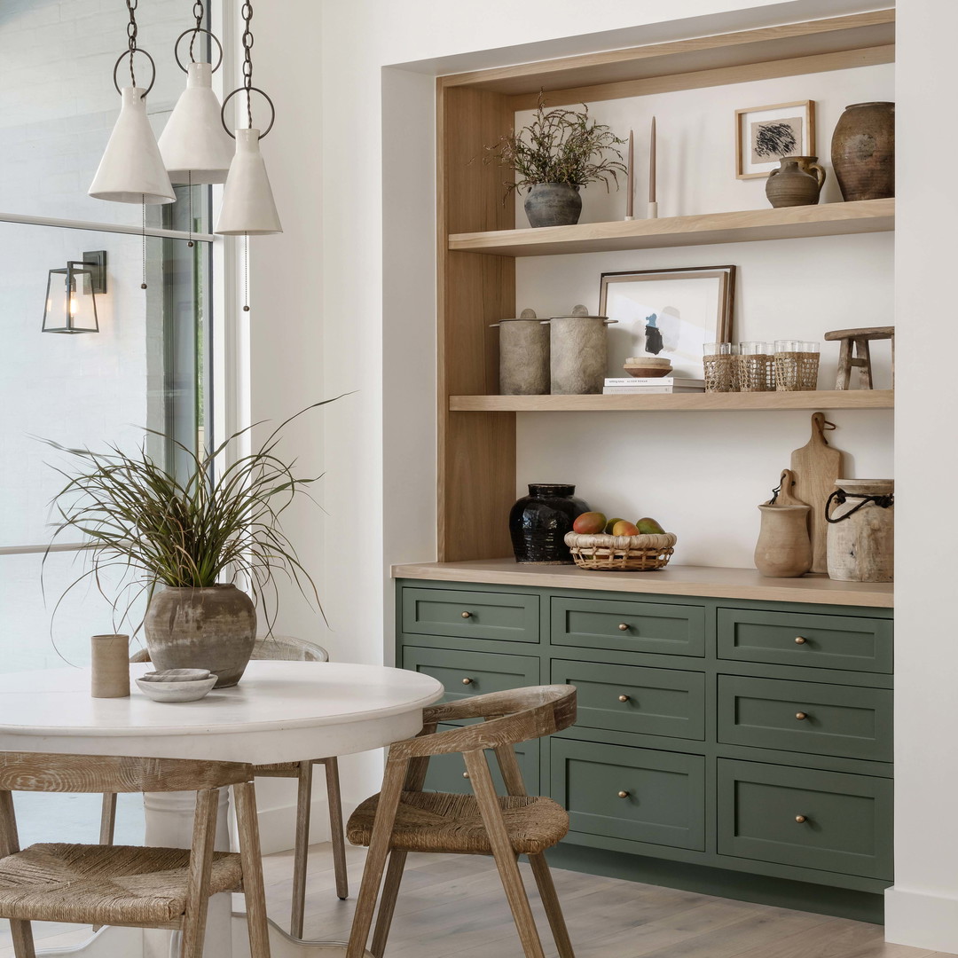 a dining room with a table and chairs