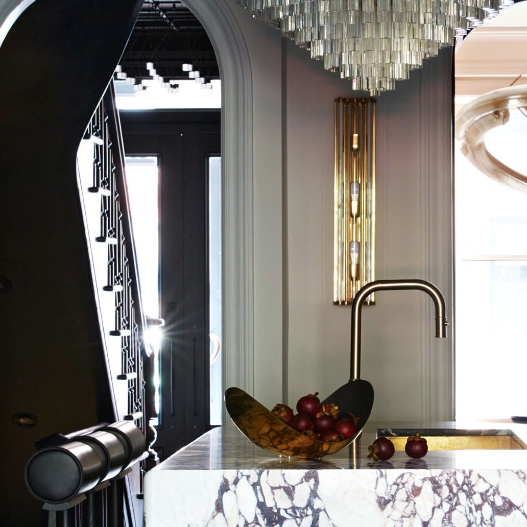 a kitchen with marble counter tops and a chandelier