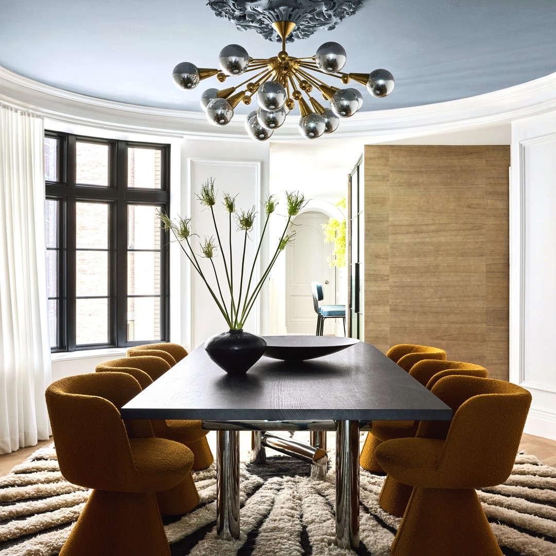 a dining room with a table, chairs and a chandelier