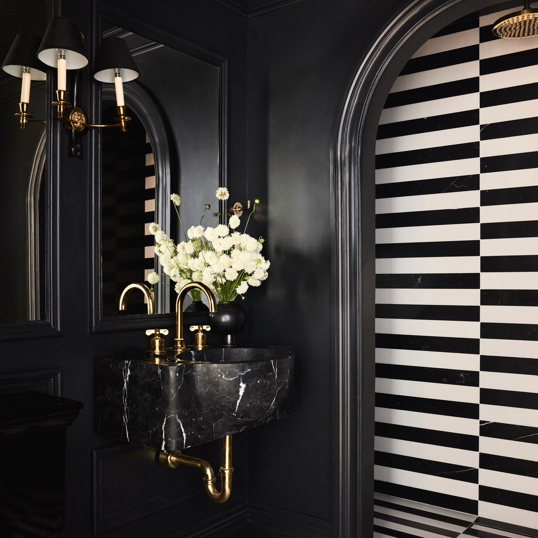 a black and white bathroom with a marble sink