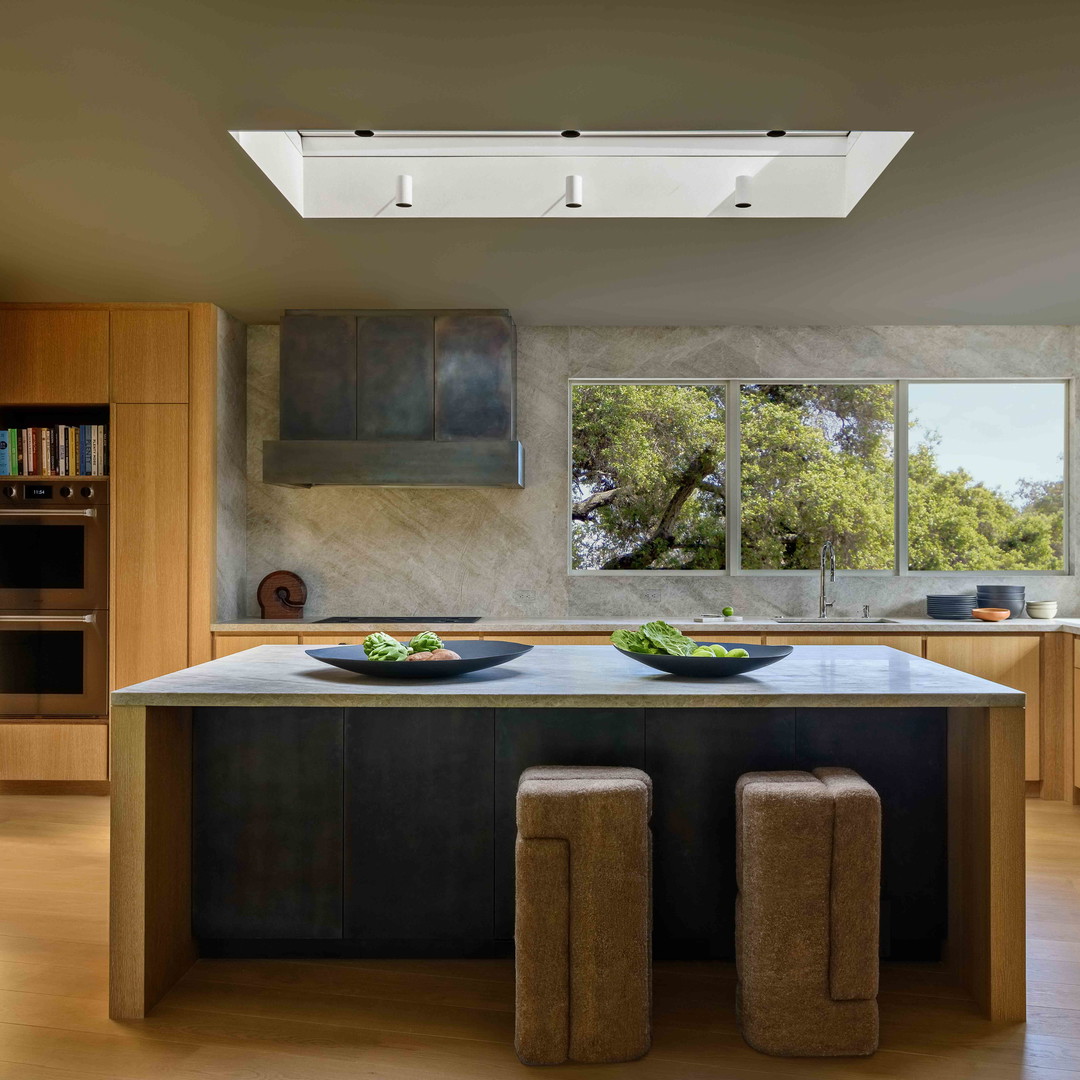 a kitchen with a center island and a skylight