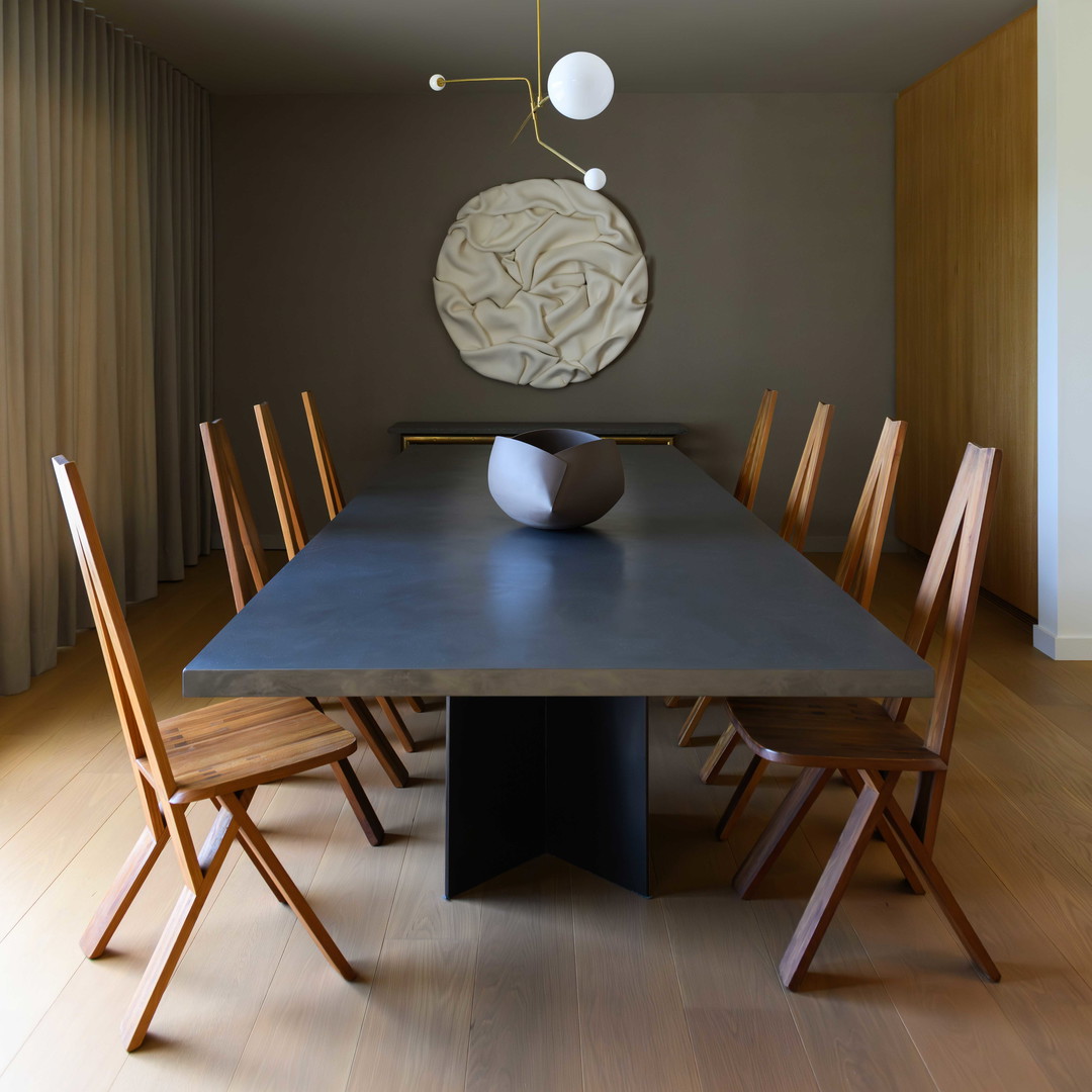 a dining room table with a vase on top of it