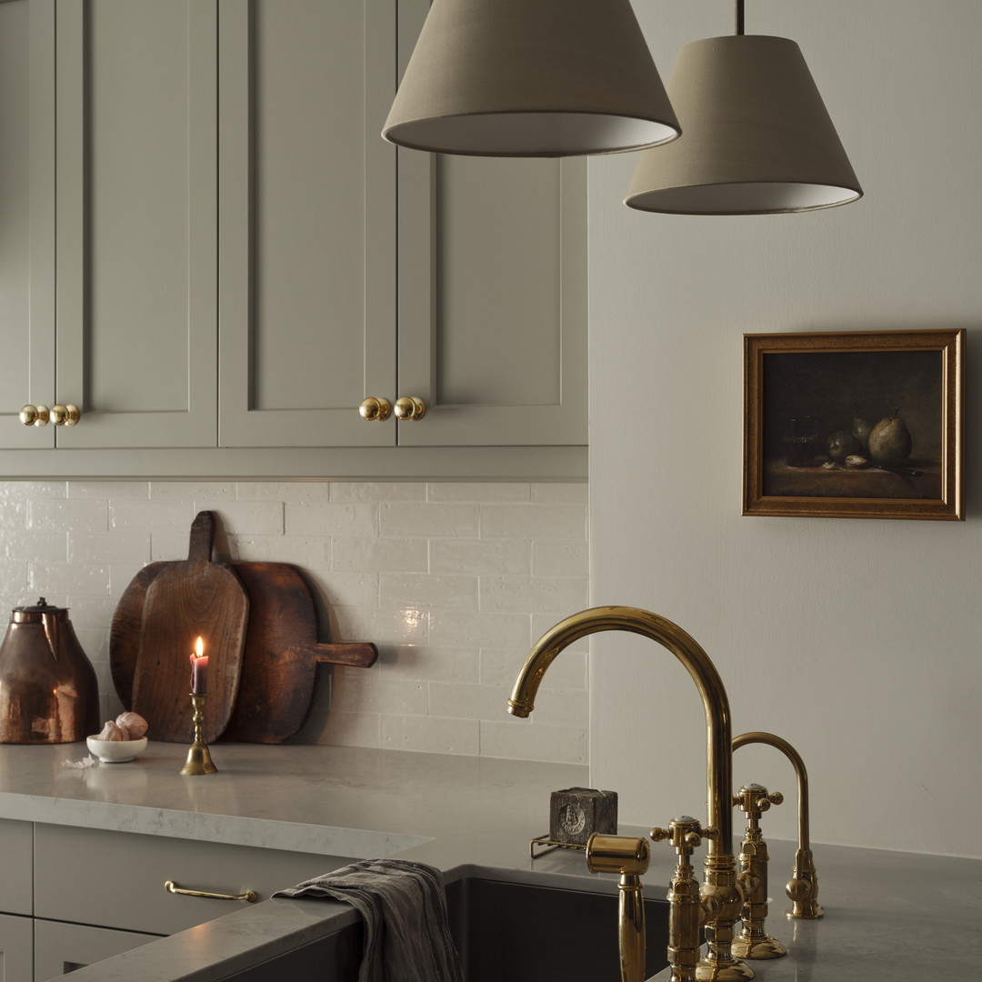 a kitchen with a sink and two hanging lights