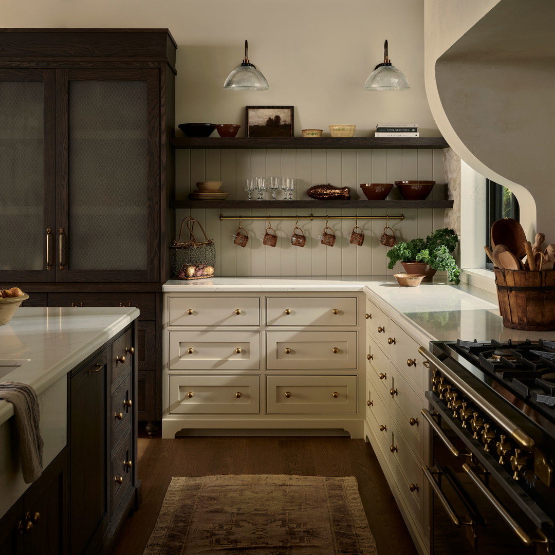 a kitchen with a stove, oven, and cabinets