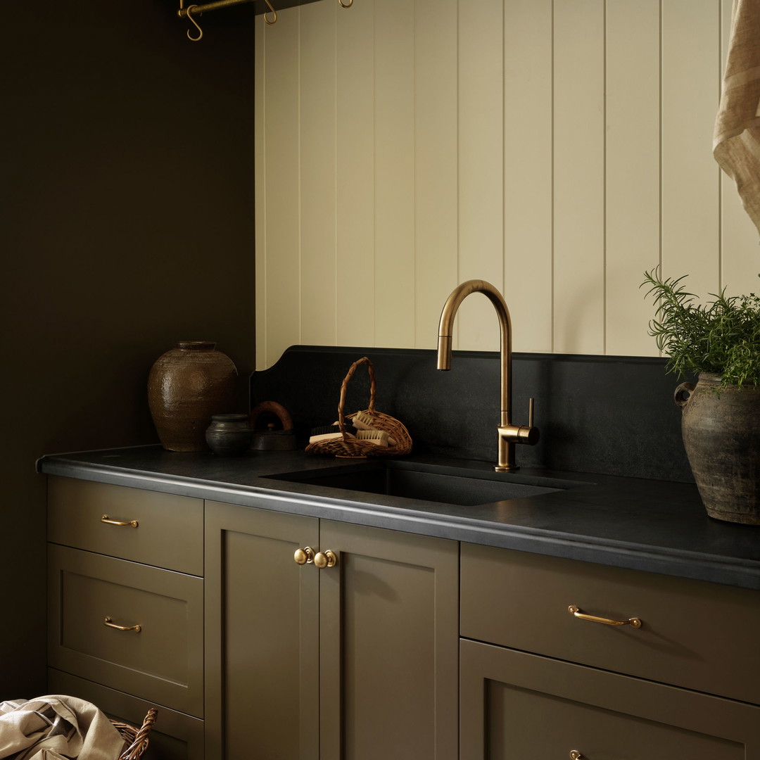 a kitchen with a sink and a potted plant