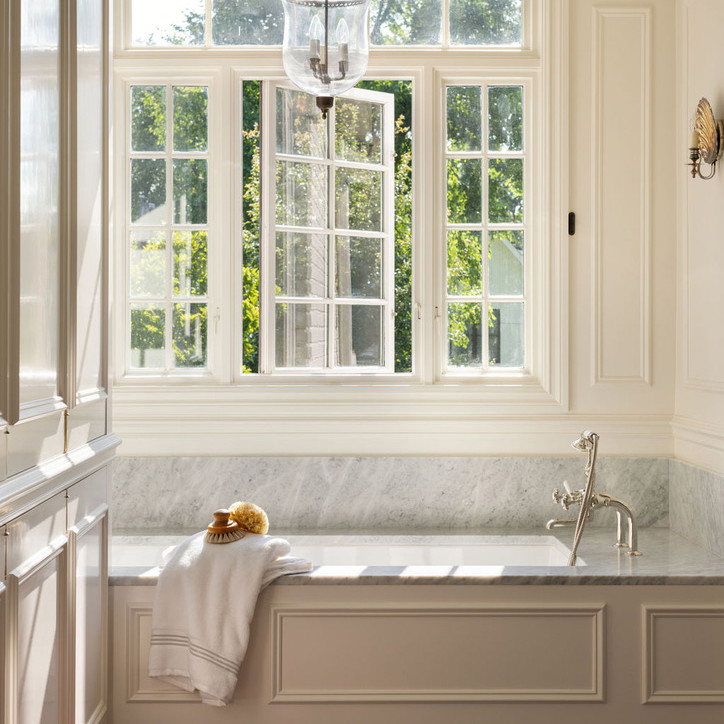 a bathroom with a large window and a bathtub