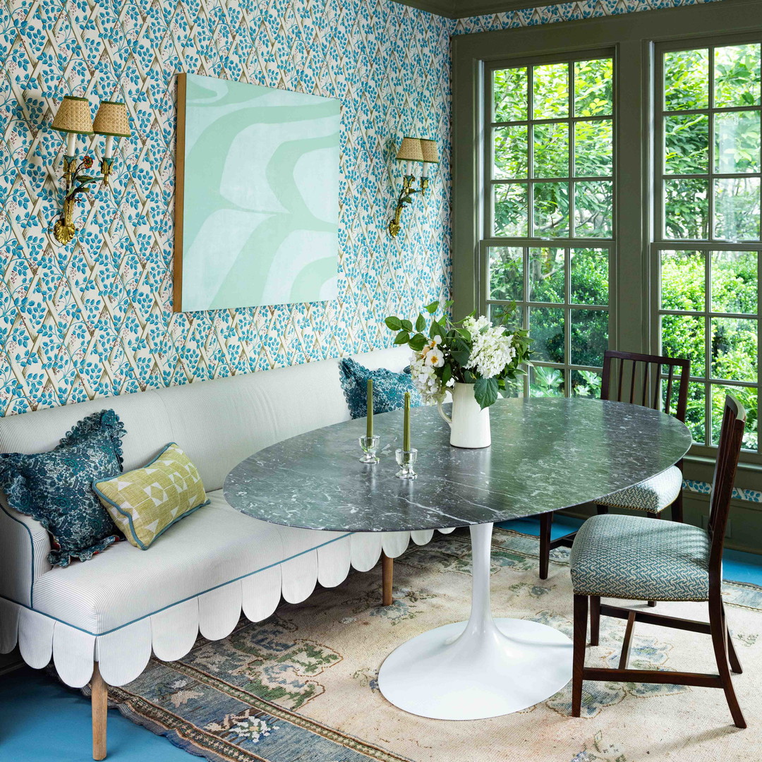 a living room with a couch, table and chairs