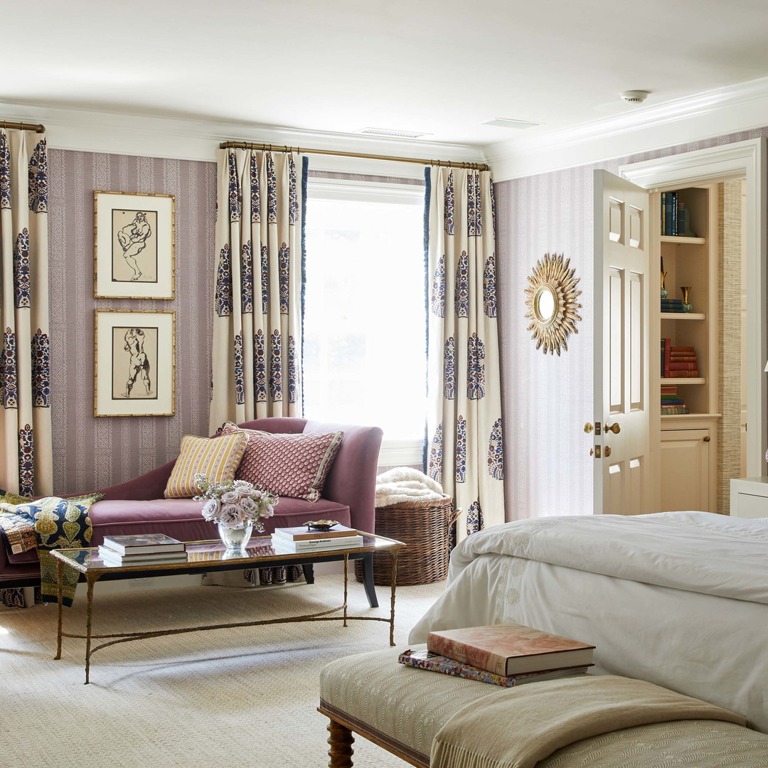 a bedroom with a bed, chairs, and a couch