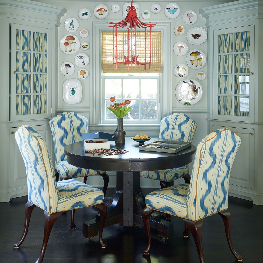 a dinning room table with blue and white chairs
