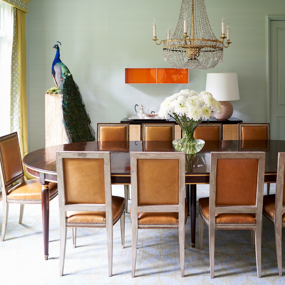 a dining room with a chandelier hanging from the ceiling