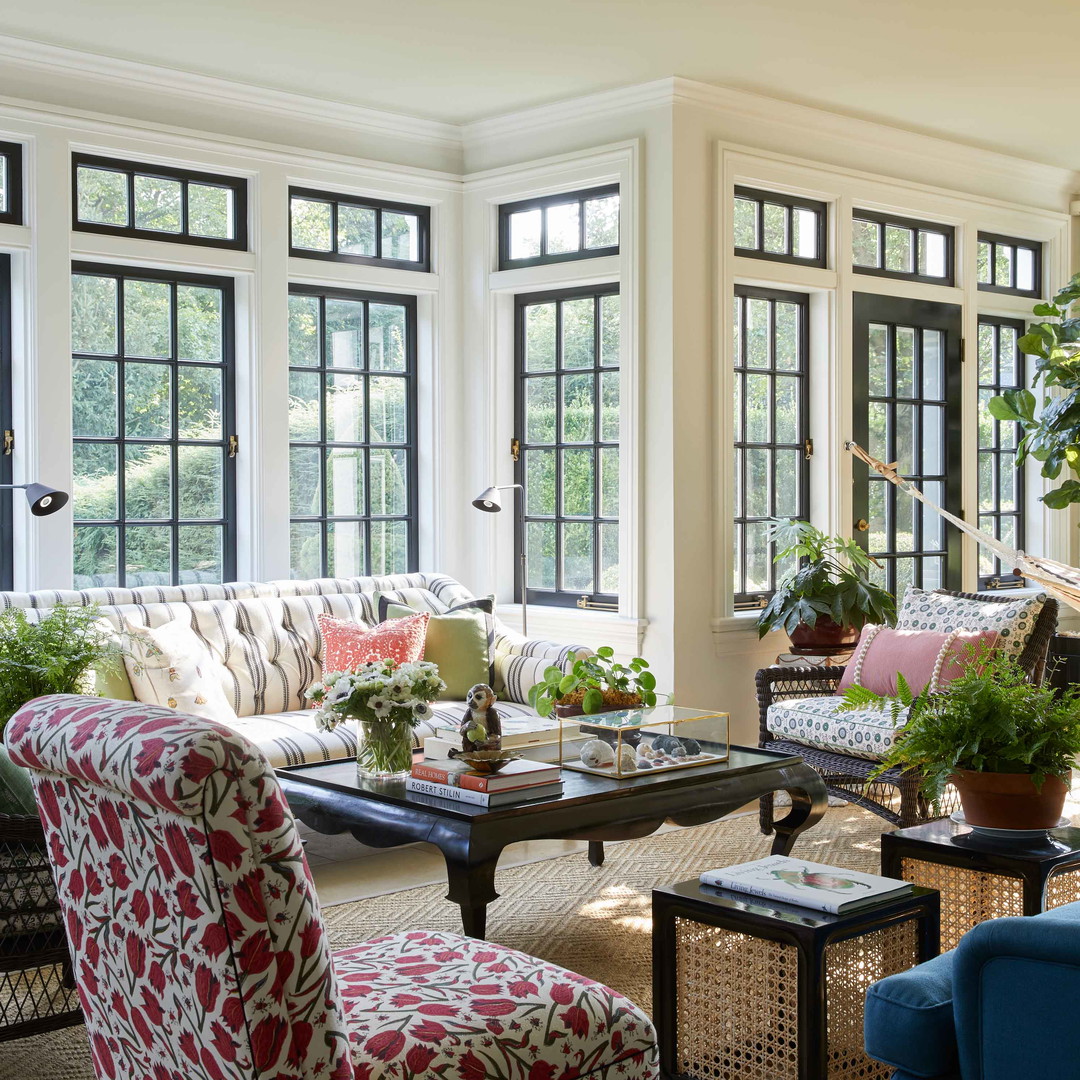 a living room filled with furniture and lots of windows