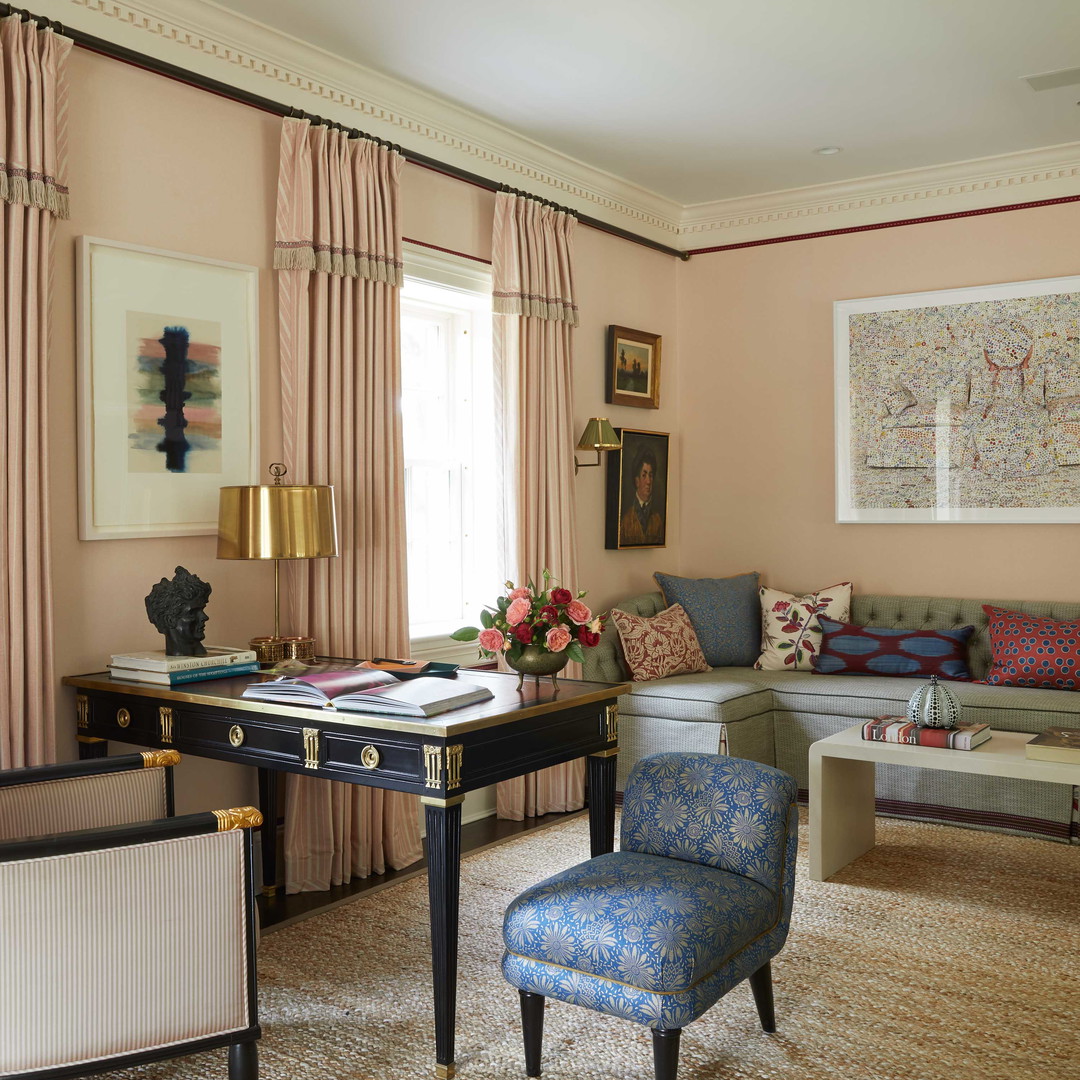 a living room filled with furniture and a painting on the wall