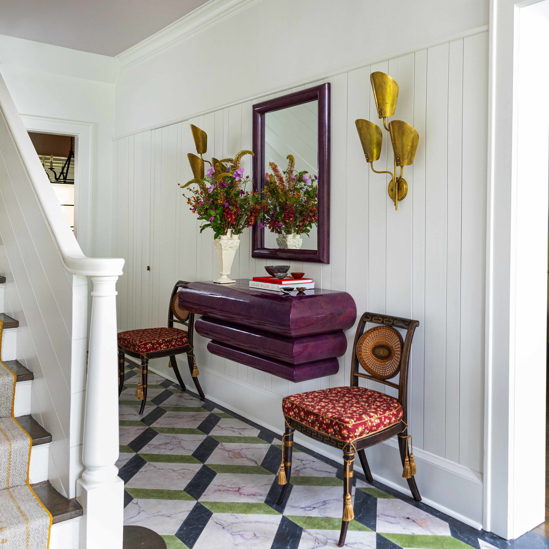 a living room with a piano and a mirror