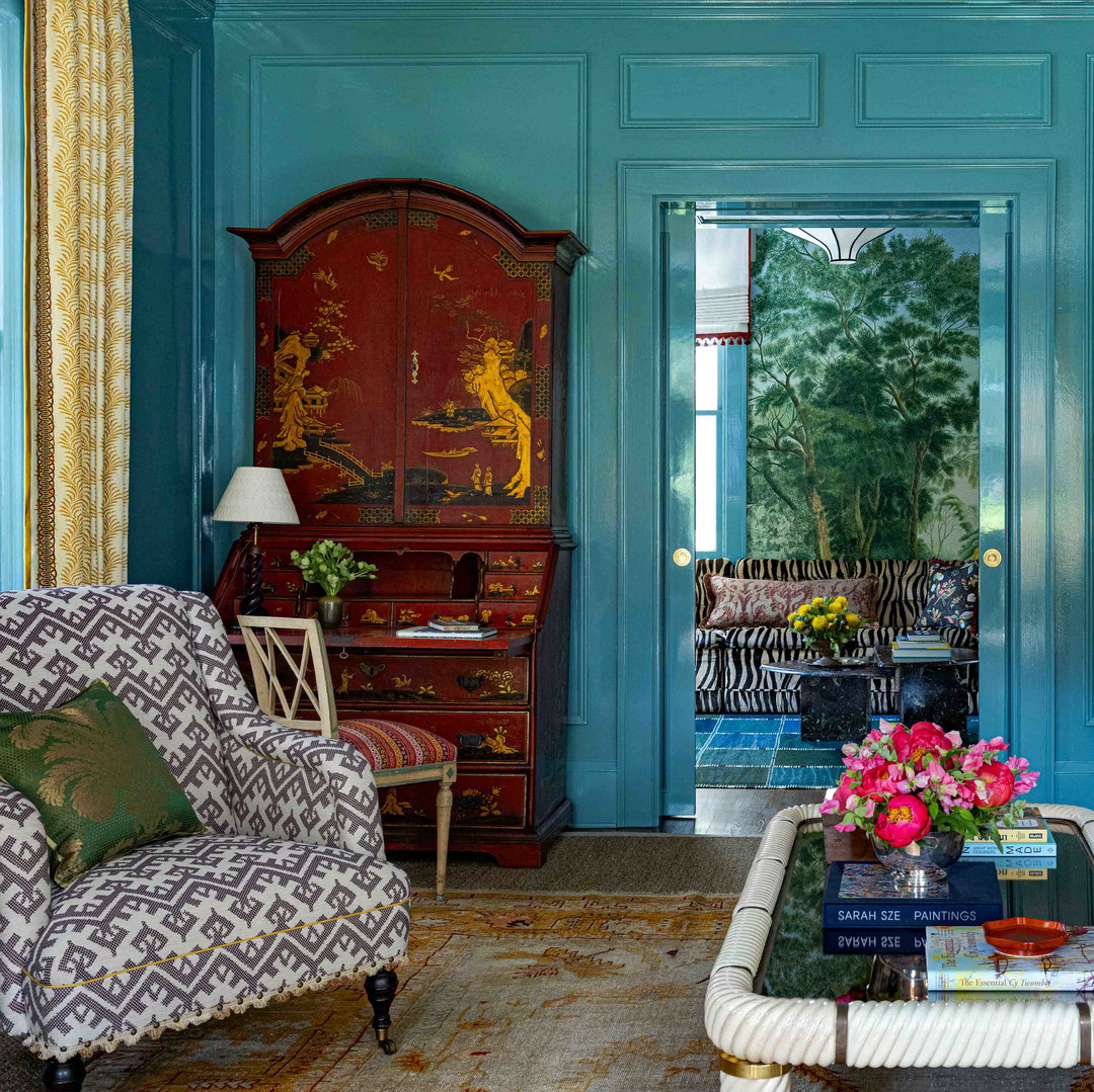a living room with blue walls and furniture