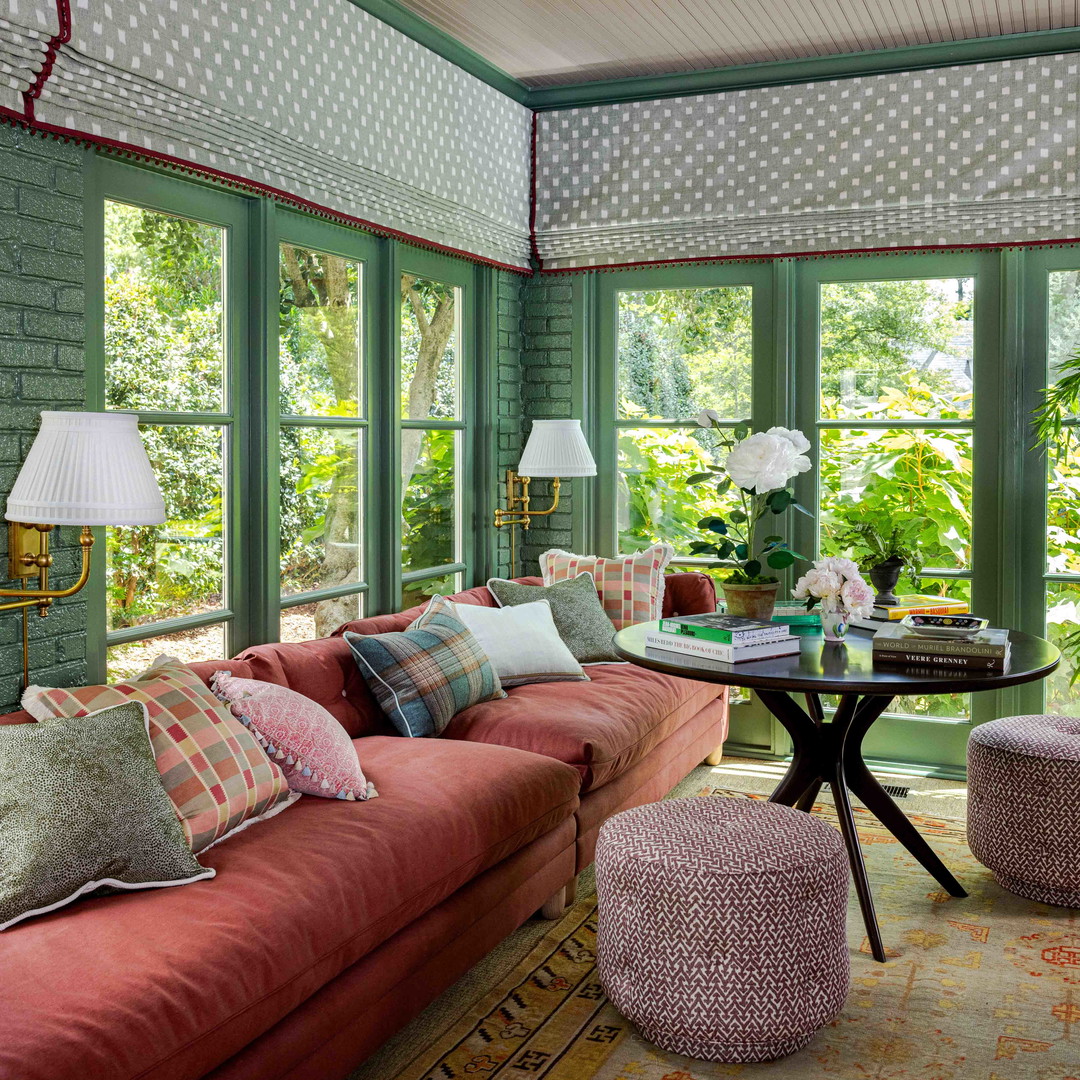 a living room filled with furniture and lots of windows